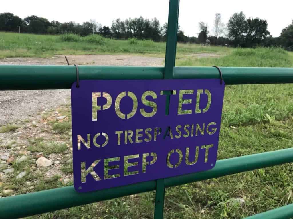 posted-no-trespassing-sign-on-gate